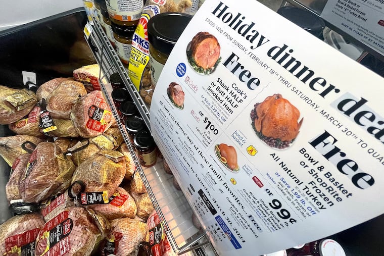 Free ham signs are shown inside a ShopRite grocery store in Lawnside, N.J., Mar. 26, 2024. Some customers say they are reaching the spending thresholds quicker than ever due to higher grocery prices.