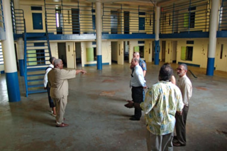 Community leaders and politicians get a tour of the now-closed Riverfront State Prison in Camden. Here, the tour is inside one of the cellblocks where the prisoners were housed. ( Clem Murray / StaffPhotographer )