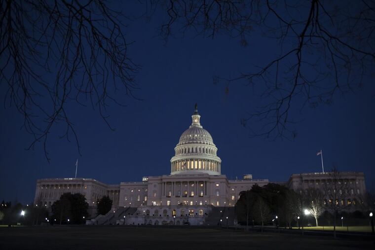 The Capitol is illuminated in Washington, Friday evening, Jan. 19, 2018.