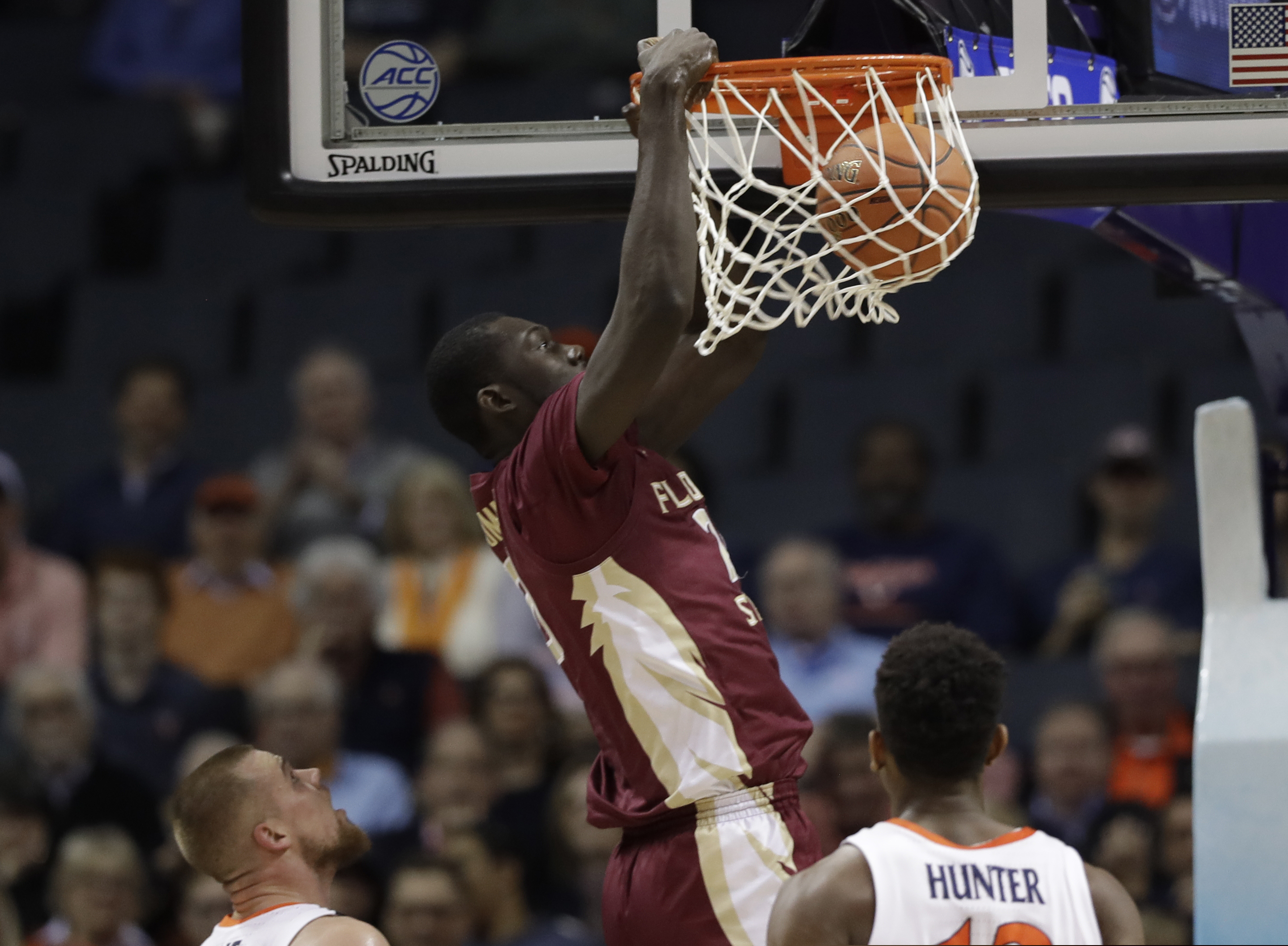 Florida State's Christ Koumadje (21) dunks against Virginia during the first half of an NCAA college basketball game in the Atlantic Coast Conference tournament in Charlotte, N.C., Friday, March 15, 2019. (AP Photo/Chuck Burton)