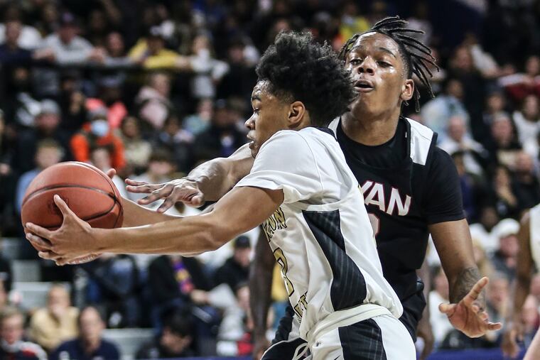 Neumann-Goretti's Khaafiq Myers drives on Ryan's Darren Williams during the 2nd quarter of the Catholic League Championship game at the Palestra in Philadelphia, Monday, February 28, 2022. Neumann-Goretti beat Ryan 61-57.