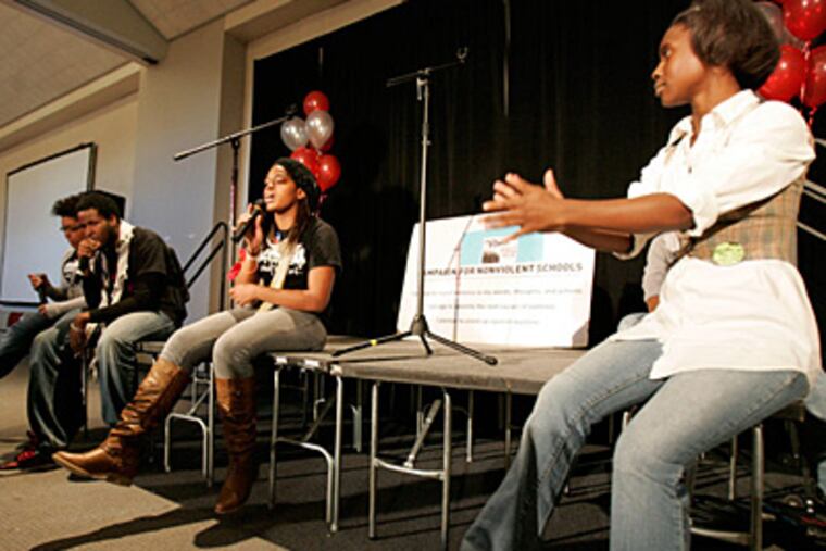 Shania Morris (middle) of the Philadelphia Student Union performs at the Youth Power Summit at Community College of Philadelphia. Clapping at right is Juele Stokes. (David Swanson / Staff Photographer)