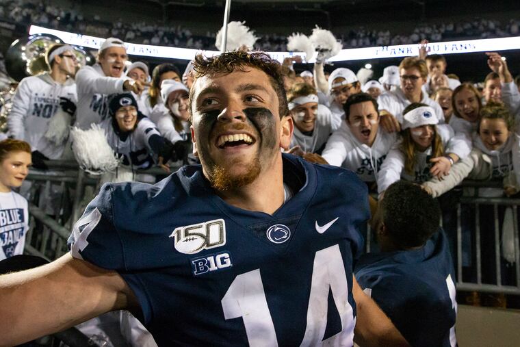 Penn State quarterback Sean Clifford celebrates with fans after his team defeated Michigan, 28-21, at Penn State's Beaver Stadium on Saturday, Oct. 19, 2019.
