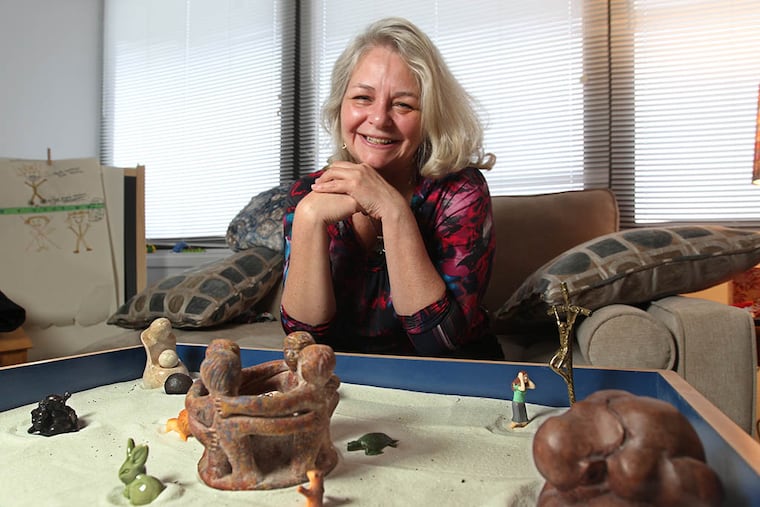 Cherry Hill therapist Carolyn Piro with her sand-tray diorama: "The subconscious always comes out in the tray." ( Michael Bryant / Staff Photographer )