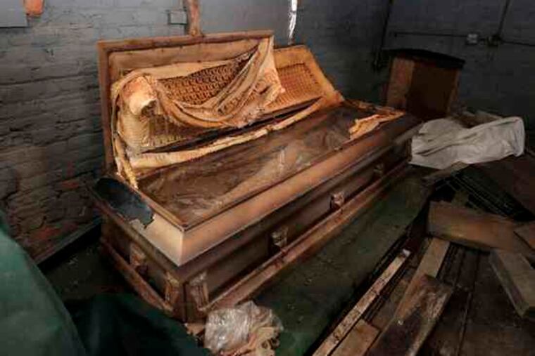 The original glass-topped casket of lynching victim Emmett Till is seen rusting in a shack at the Burr Oak Cemetery in Alsip, Ill.