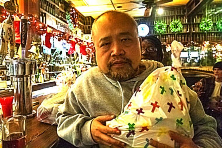 Linh Dinh, author of "Postcards from the End of America," in Jack's Famous Bar on Christmas Eve.