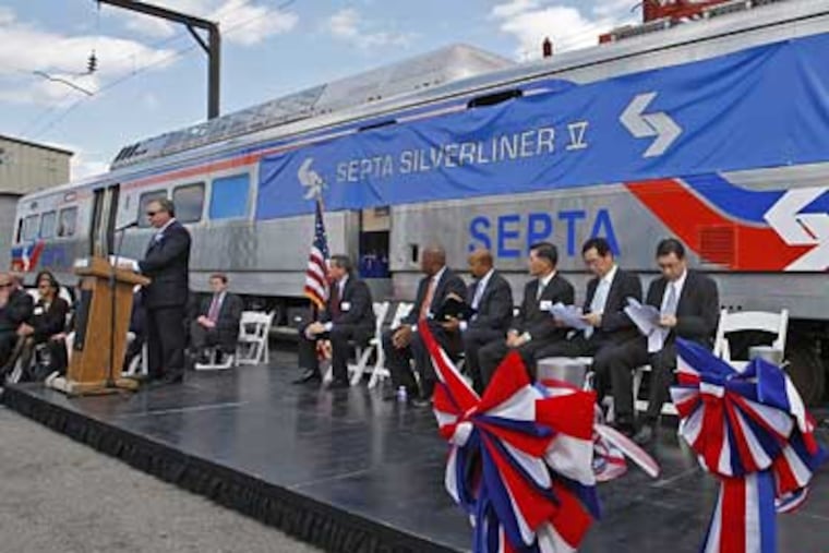 Pasquale T. Deon (left), Sr., chairman of the board, speaks about SEPTA's new rail car. (Michael S. Wirtz / Inquirer)