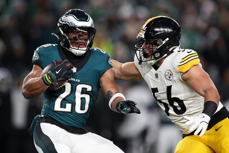 Eagles running back Saquon Barkley carries past Pittsburgh Steelers linebacker Alex Highsmith during the first quarter of the game against the Pittsburgh Steelers on Sunday, Dec. 15, 2024, at Lincoln Financial Field.