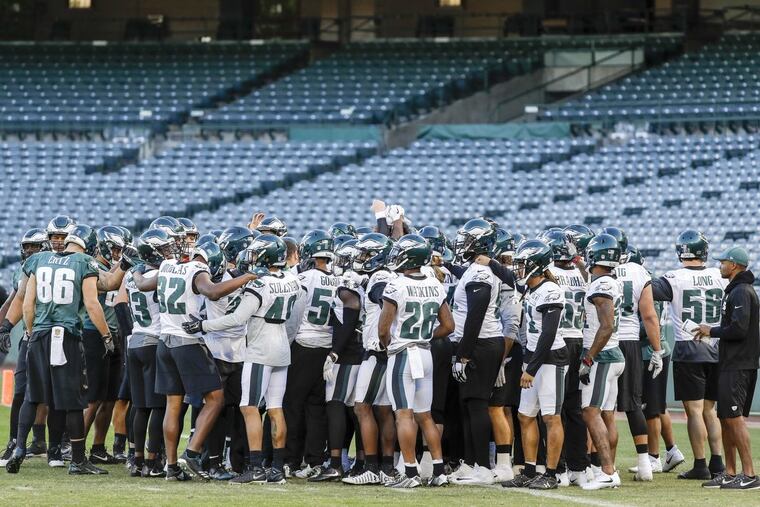 The Eagles gather before the start of practice at the Angles Stadium of Anaheim in Anaheim, California on Thursday, December 7, 2017. YONG KIM / Staff Photographer