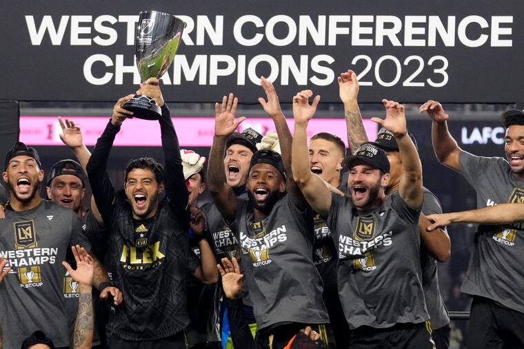 LAFC players celebrate with the Western Conference championship trophy.