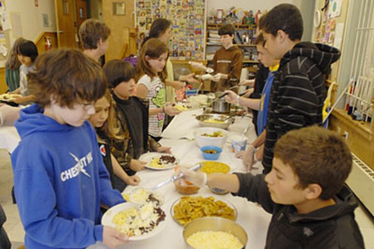 Braden Clark is served by Gabe Beresin at Project Learn. (RON TARVER / Staff Photographer)