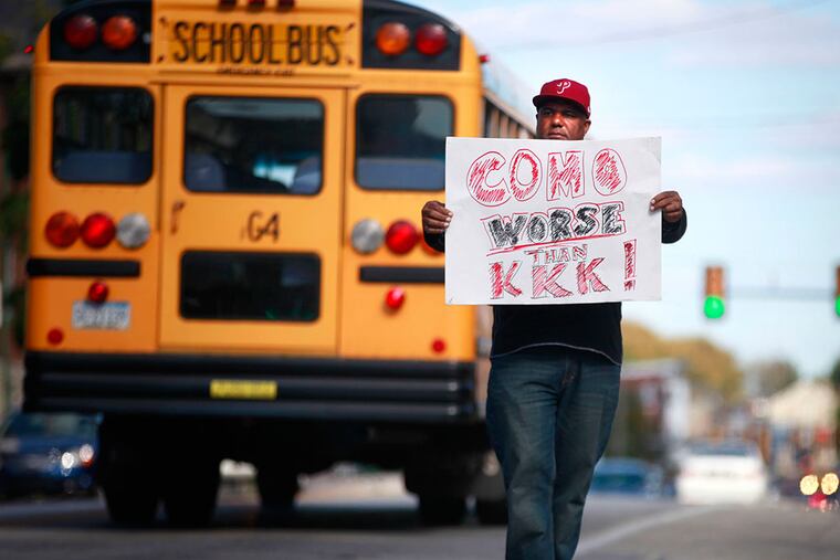 Ron Suber stands in the middle East Lincoln Highway protesting Richard Como, the superintendent, and Jim Donato, director of athletics at the Coatesville Senior High School, on Monday. DAVID SWANSON / Staff Photographer