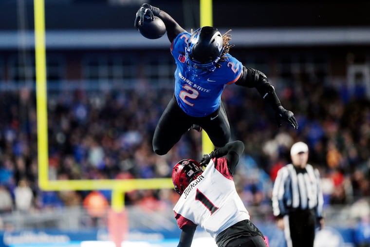 Boise State running back Ashton Jeanty leaps over San Diego State cornerback Chris Johnson on Nov. 1.