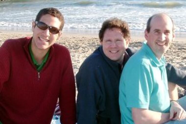 Sheldon Bowman-Brunk was adopted last year, after nine years in homes and shelters, by Lloyd Bowman (center) and Doug Brunk.