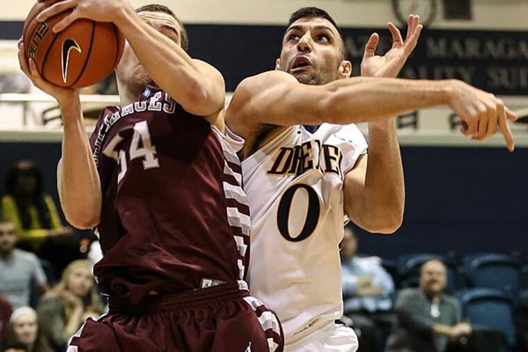 University of Sciences' Will Gregorits (left) grabs the rebound away from
Drexel's Sooren Derboghosian. (Steven M. Falk/Staff Photographer)