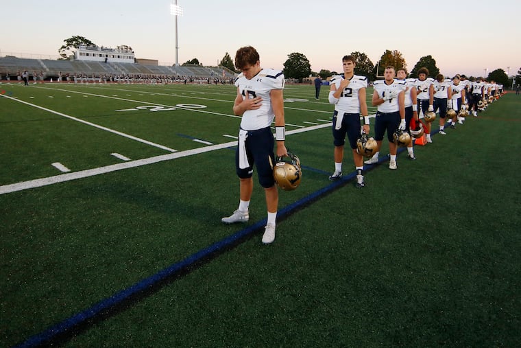 La Salle players stand during the National Anthem and then a moment of silence for fallen teammate Isaiah Turner Friday night.