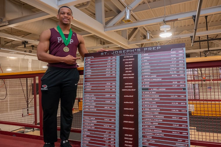 St. Joseph's Prep's Elijah Jones, 18, of Norristown, points to the school's 60 meter-dash record that he broke, previously held by D'Andre Swift.