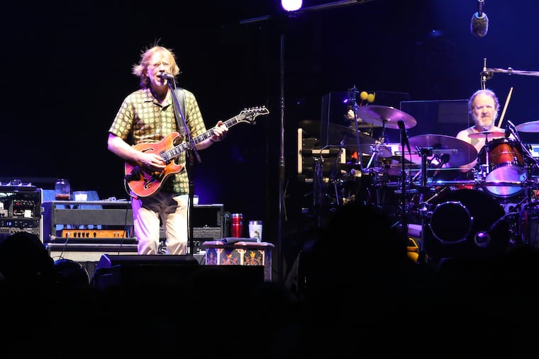 Phish lead guitarist Trey Anastasio, drummer Jon Fishman, and the band, perform on the beach in Atlantic City Friday night.