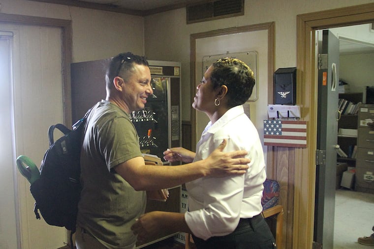 In this June 27, 2014 photo, Navy veteran Rik Villarreal greets American Legion official Verna Jones at the El Paso American Legion in El Paso, Texas. The American Legion is hosting crisis centers in different cities to help veterans get doctor’s appointments and benefits from the Department of Veterans Affairs. (AP Photo/Juan Carlos Llorca)