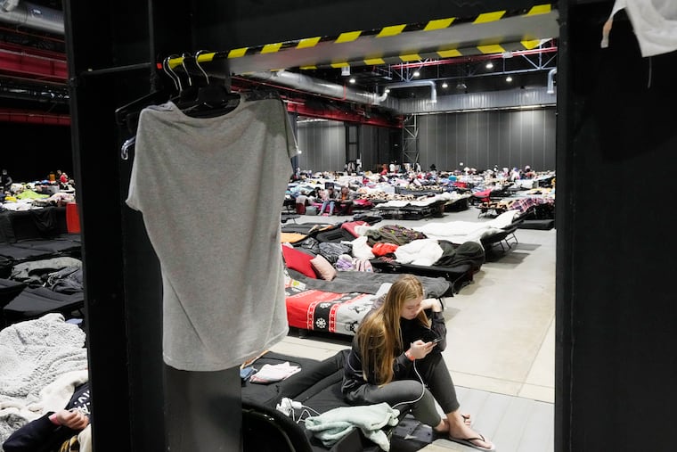 Refugees from Ukraine stay inside a vast accommodation center set up at the Global EXPO exhibition hall in Warsaw, Poland, on Tuesday.