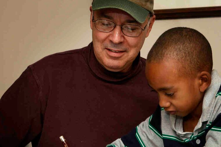 Artist Adrian Martinez works with Jaden to come up with ideas for a planned mural. Four Chester County artists worked with nine children who live in emergency shelters in the county.