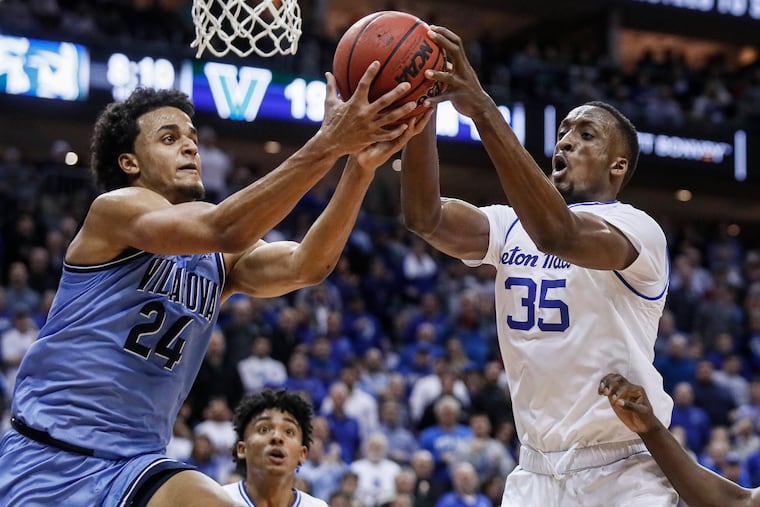 Villanova's Jeremiah Robinson-Earl (24) and Seton Hall's Romaro Gill (35) battle for a rebound during the first half.