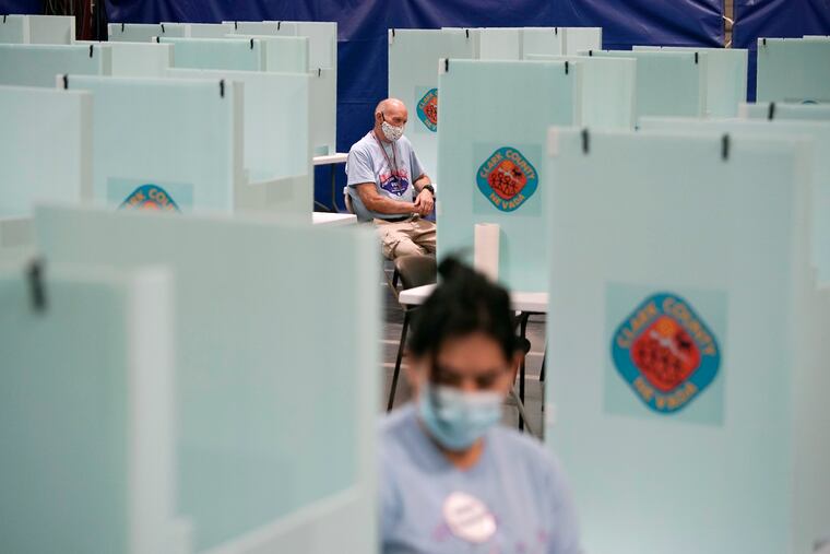 This June 9 photo shows election workers at one of a few in-person voting places in Las Vegas during a nearly all-mail primary election.