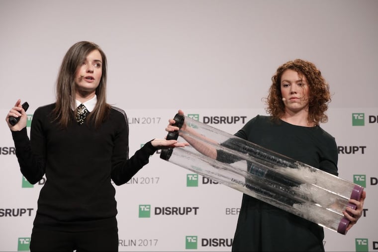 Bethany Edwards (left) and Anna Simpson demonstrate how the Lia pregnancy test is biodegradable by breaking up in water at TechCrunch Disrupt Berlin Tuesday. Lia Diagnostics were the overall winner of the competition.