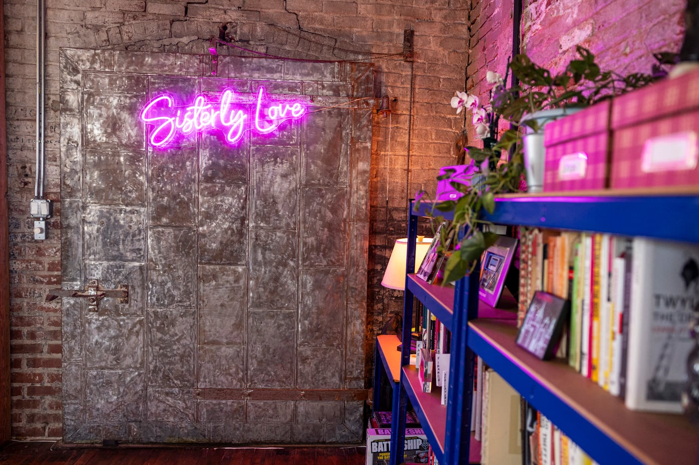 Carroll is a cofounder of the Sisterly Love Collective, which supports women chefs. The pink neon logo glows on the tin door of an out-of-use elevator shaft.