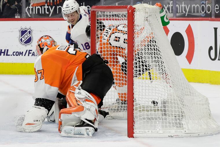 The Islanders' Anthony Beauvillier slides in the overtime winner on a wraparound past Flyers goaltender Brian Elliott.