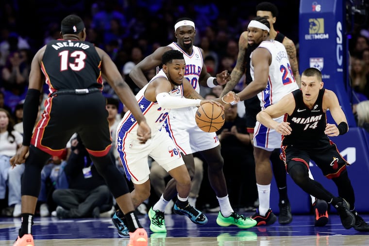 Sixers forward Justin Edwards steals the basketball against Miami Heat guard Tyler Herro and center Bam Adebayo in the first quarter on Saturday, March 29, 2025 in Philadelphia.