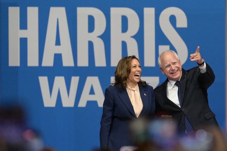 Democratic presidential nominee Kamala Harris and her running mate, Minnesota Gov. Tim Walz, take the stage during a rally at the Liacouras Center on Aug 6, 2024.