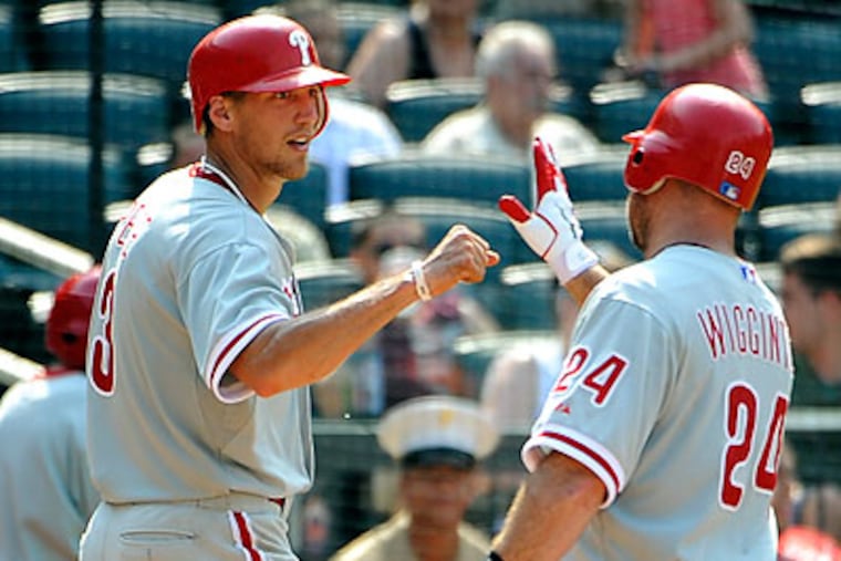Hunter Pence greets Ty Wigginton at home plate after Wiggington hit a three-run home run in the ninth inning. (Kathy Kmonicek/AP)