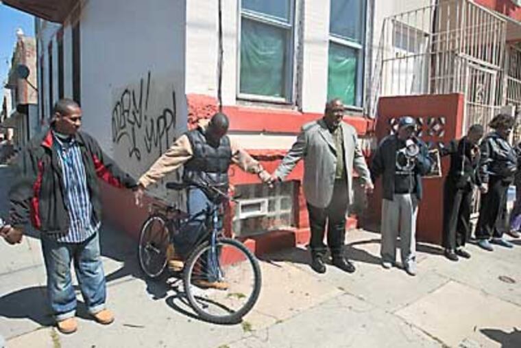 State Rep. W. Curtis Thomas (center) joins residents near Ninth and Cambria Streets. RON TARVER / Staff Photographer