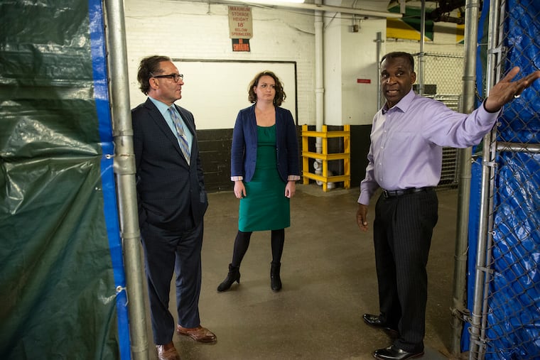 Lin Thomas (right), CEO of Supra Office Solutions Inc., and a partner in EMSCO Scientific Enterprises Inc., in the companies' warehouse in West Philadelphia with the Economy League of Greater Philadelphia's Jeff Hornstein and Mariya Khandros, leaders of a new buy-local initiative that helped EMSCO land a big contract with the University of Pennsylvania in partnership with ThermoFisher Scientific.