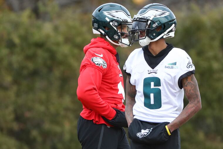 Eagles quarterback Jalen Hurts and wide receiver DeVonta Smith (6) take a break during practice at the NovaCare Complex on Thursday.