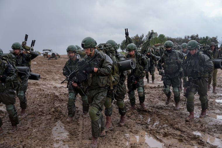 Israeli soldiers prepare to enter the Gaza Strip, at a staging area near the Israeli-Gaza border, in southern Israel on Wednesday.