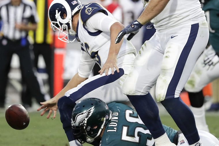 Eagles defensive end Chris Long forces a fumble on Los Angeles Rams quarterback Jared Goff and past offensive tackle Andrew Whitworth during the fourth-quarter on Sunday, December 10, 2017. YONG KIM / Staff Photographer