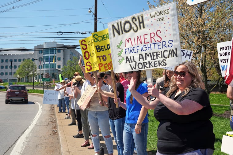 People rally in April in support of some 185 researchers and other employees of the National Institute for Occupational Safety and Health (NIOSH) in Morgantown, W.Va., who received reduction-in-force notices.