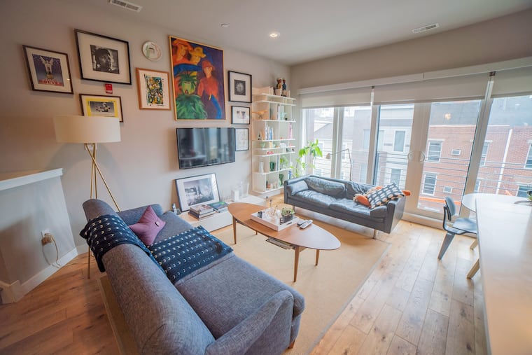 The trinity’s lower level opens into a kitchen/living room with floor-to-ceiling windows.