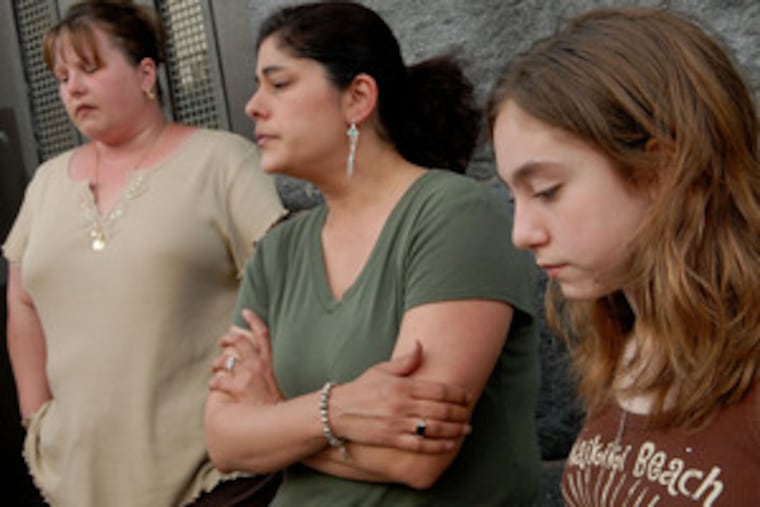 "They hurt the children," says Lora Hall (center), standing outside A.S. Jenks Elementary School in South Philadelphia with daughter Felicia, 10, and another Jenks parent, Phyllis Lucia (left). The raffle money was taken from a cabinet in the locked principal's office.