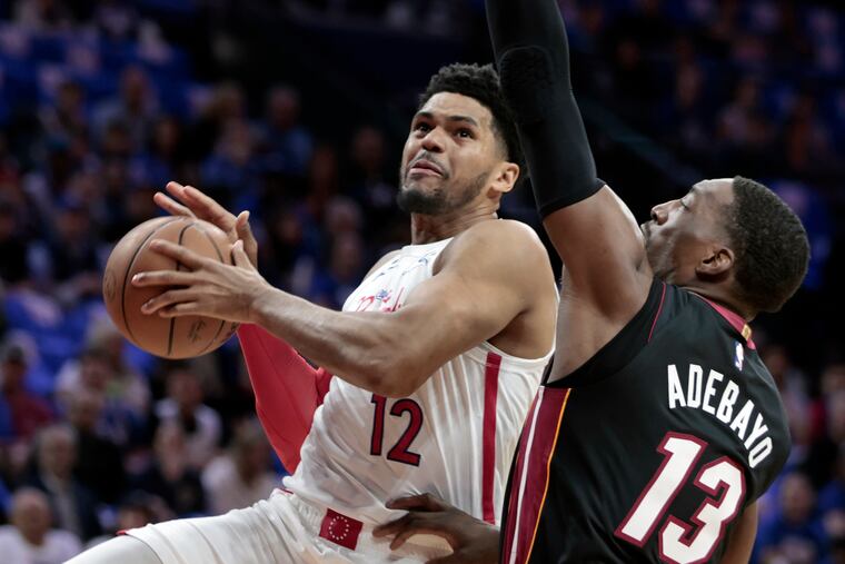 Sixers Tobias Harris goes to the net despite defense by Miami’s # 13 Bam Adebayo.