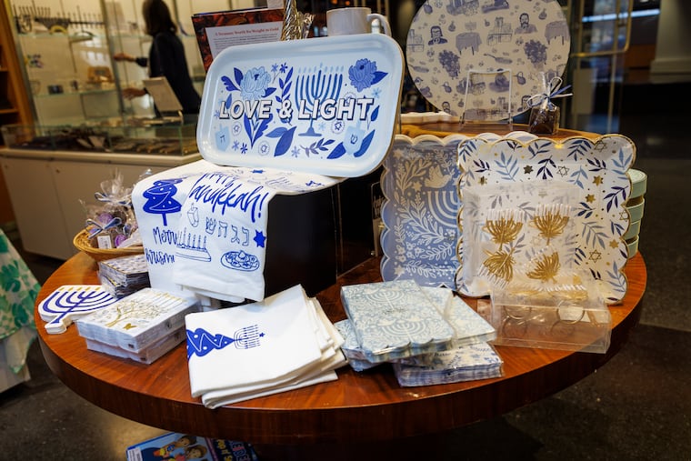 Hanukkah paper plates, napkins, napkin rings, and tea towels are available at the Weitzman National Museum of American Jewish History store, where fourth-quarter business is more than double what it is in other quarters due to the holiday.