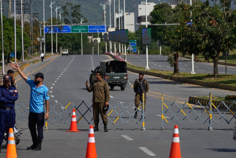 Police officers stand guard at a checkpoint ahead of the second round of negotiations between the U.S. and Iran, in Islamabad, Pakistan, Tuesday, April 21, 2026.