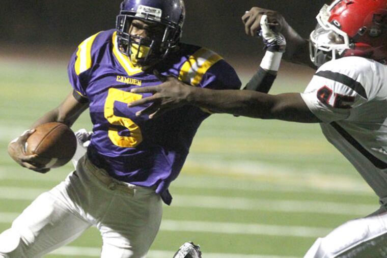 Camden quarterback Khalil Williams avoids the grasp of Kingsway's Tyler Keen and runs for a touchdown. (Charles Fox/Staff Photographer)