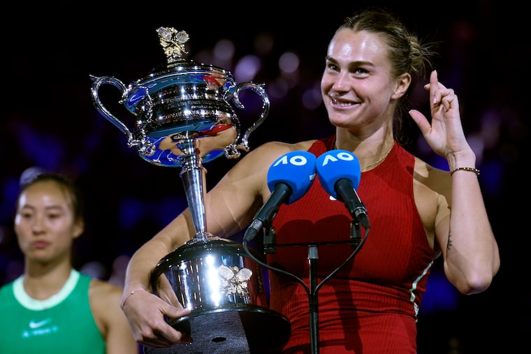 Aryna Sabalenka of Belarus holds the Daphne Akhurst Memorial Cup after defending her Australian Open women's singles title.