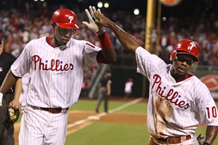 John Mayberry Jr. celebrates his home run against the Reds with Juan Pierre. (Ron Cortes/Staff Photographer)