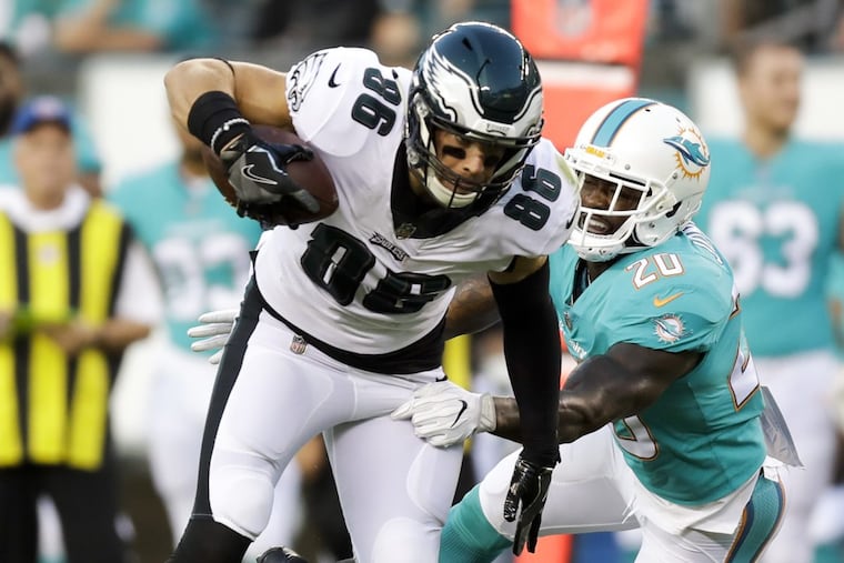 Eagles tight end Zach Ertz runs with the football past Miami Dolphins free safety Reshad Jones on Thursday night.