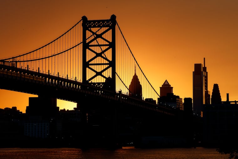 The sun sets behind the Ben Franklin Bridge, seen from Cooper's Poynt Park at the of September. It will be setting a lot earlier Sunday.