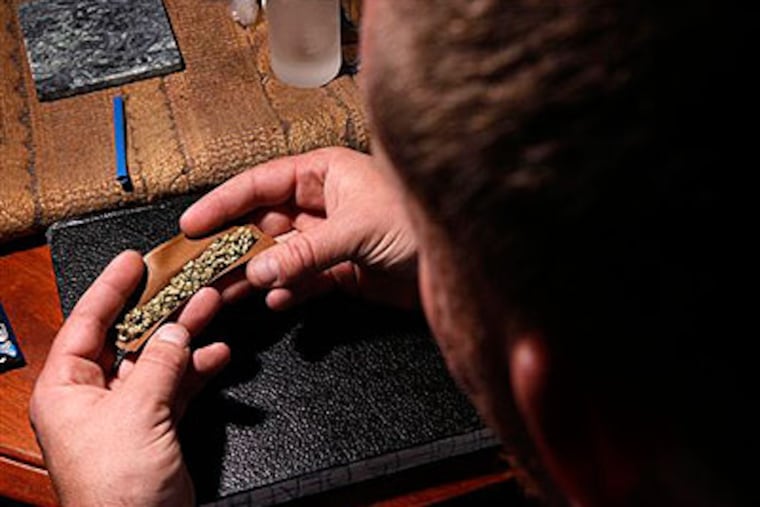 A medical-marijuana user rolls prepares to smoke at home, Thursday, Oct. 22, 2009, in Portland, Maine. A decade ago, Maine voters overwhelmingly approved a referendum allowing people to legally possess marijuana for medicinal purposes. Will Pennsylvania and New Jersey follow suit? (AP Photo / Robert F. Bukaty)